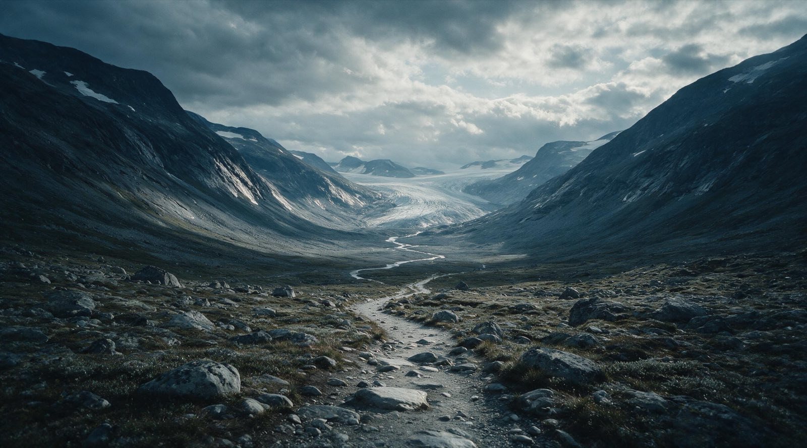 A winding trail leading into a broad mountain valley