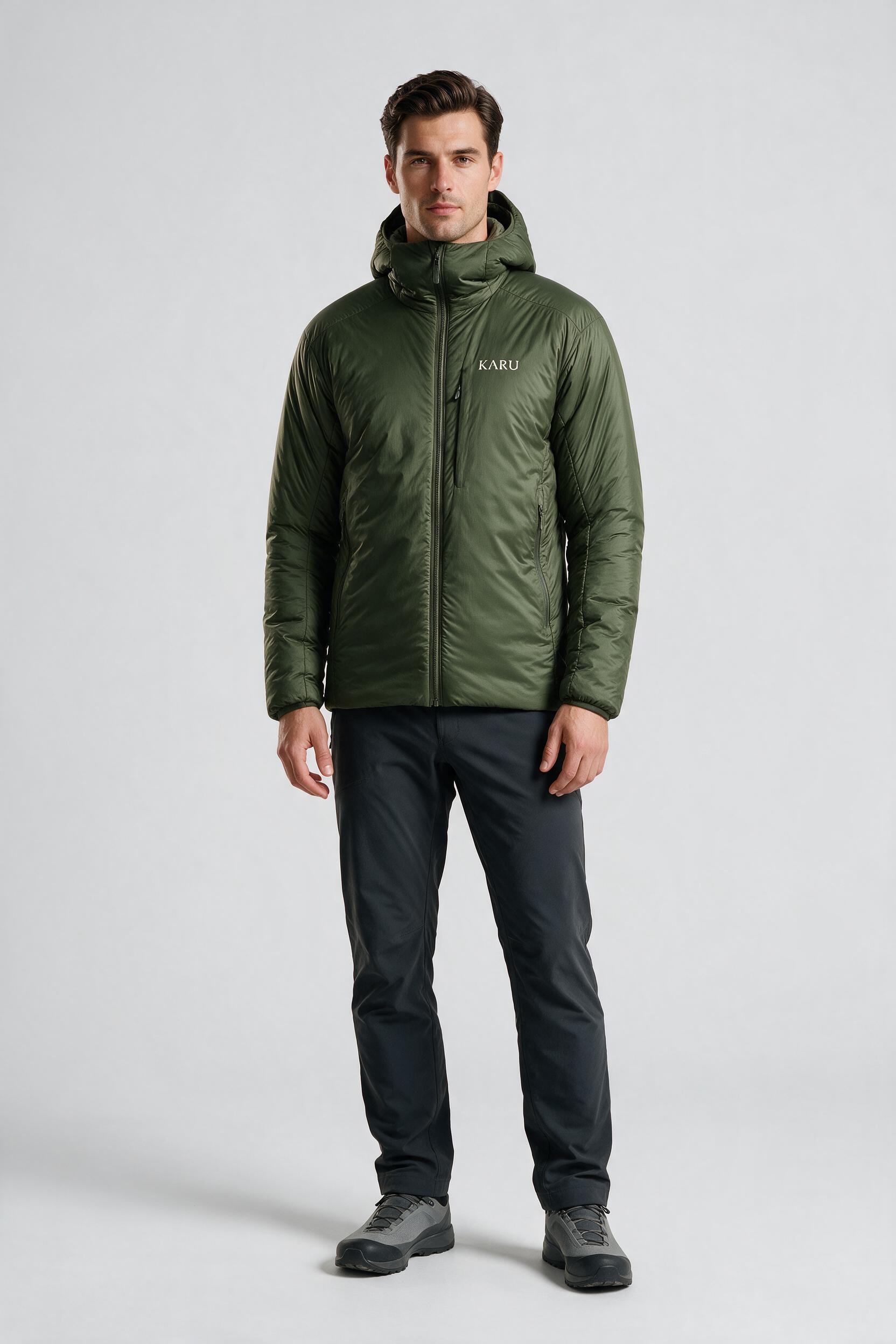 Aktse Insulated in deep moss, worn by a model, studio product shot on a seamless neutral ground