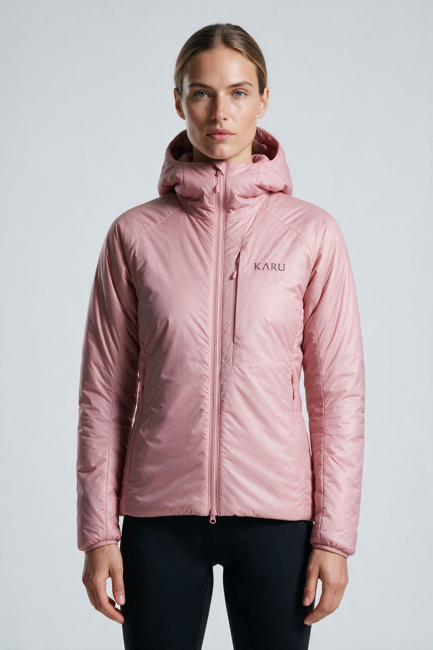 Aktse Insulated Rose in pale rose pink, worn by a model, studio product shot on a seamless neutral ground