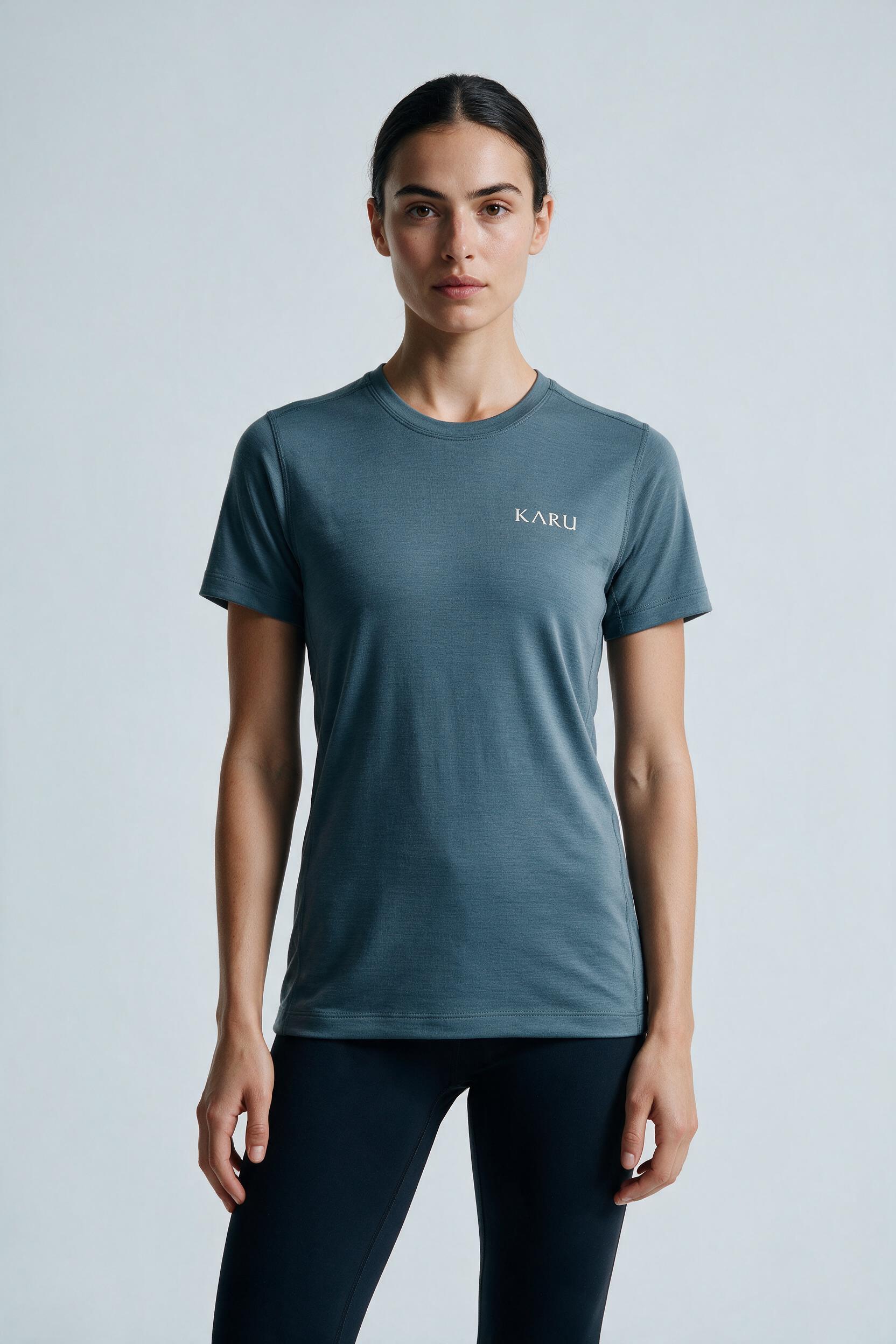 Hetta Tee in slate blue-grey, worn by a model, studio product shot on a seamless neutral ground