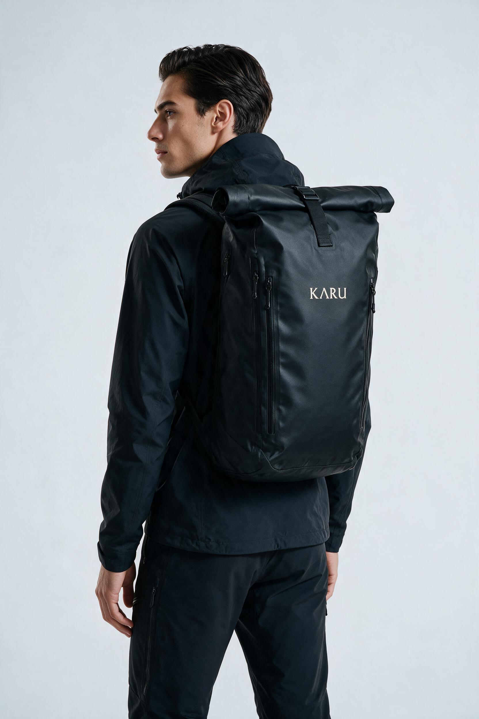 Kaitum 28 backpack in black, worn on the back, studio product shot on a seamless neutral ground