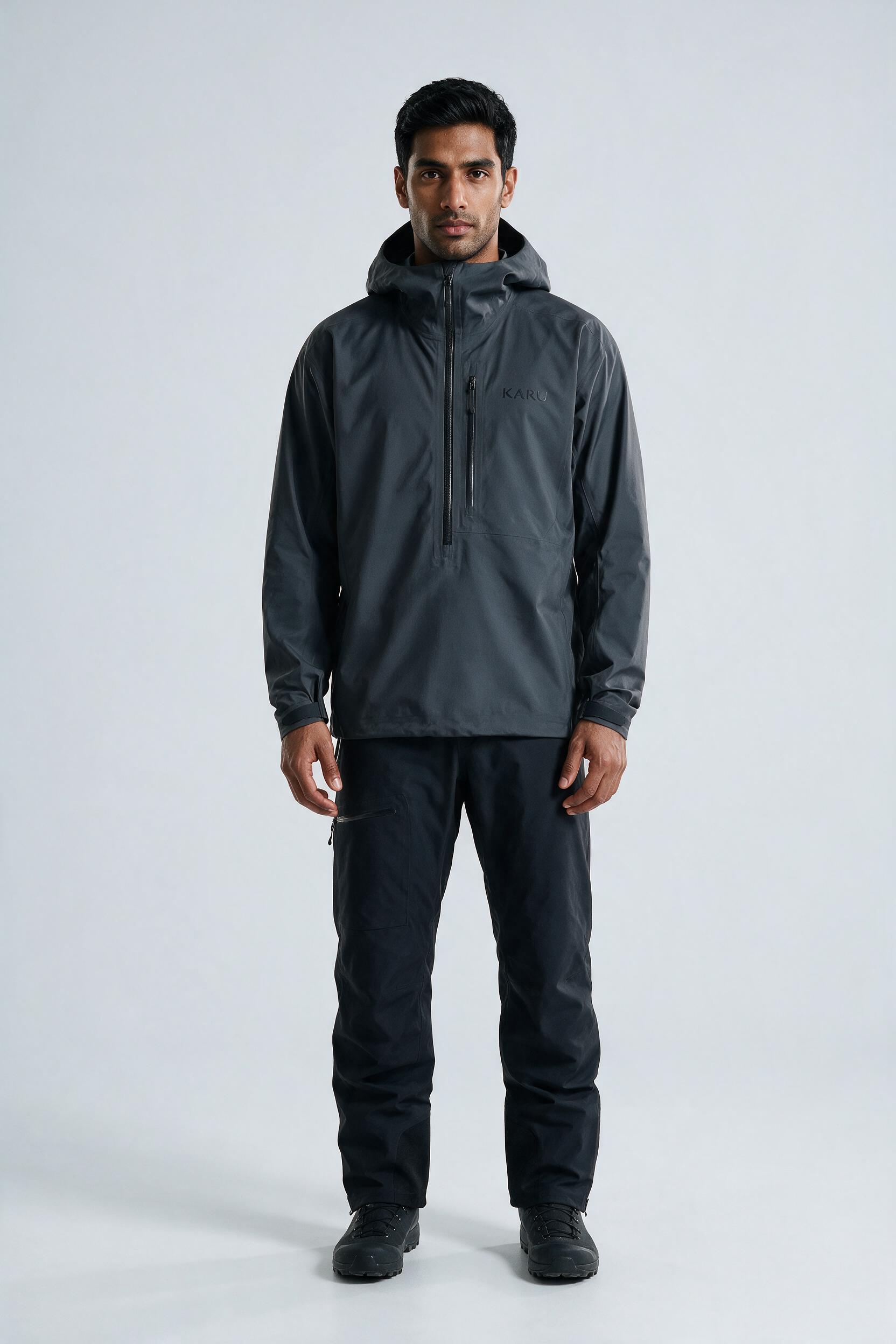 Kårsa Anorak Graphite in dark graphite grey, worn by a model, studio product shot on a seamless neutral ground