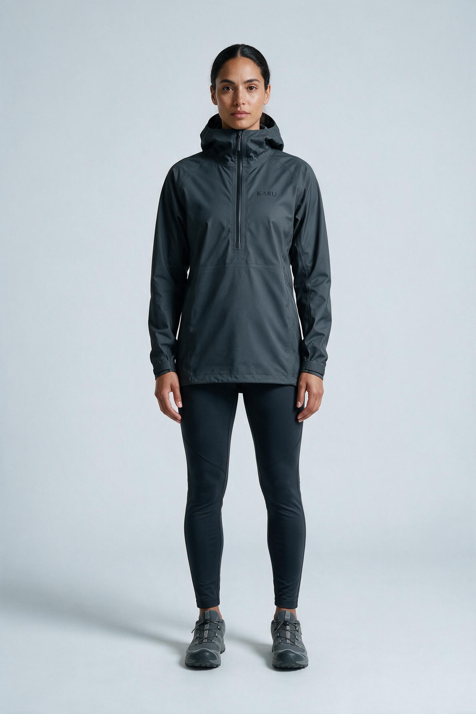 Kårsa Anorak Graphite in dark graphite grey, worn by a model, studio product shot on a seamless neutral ground