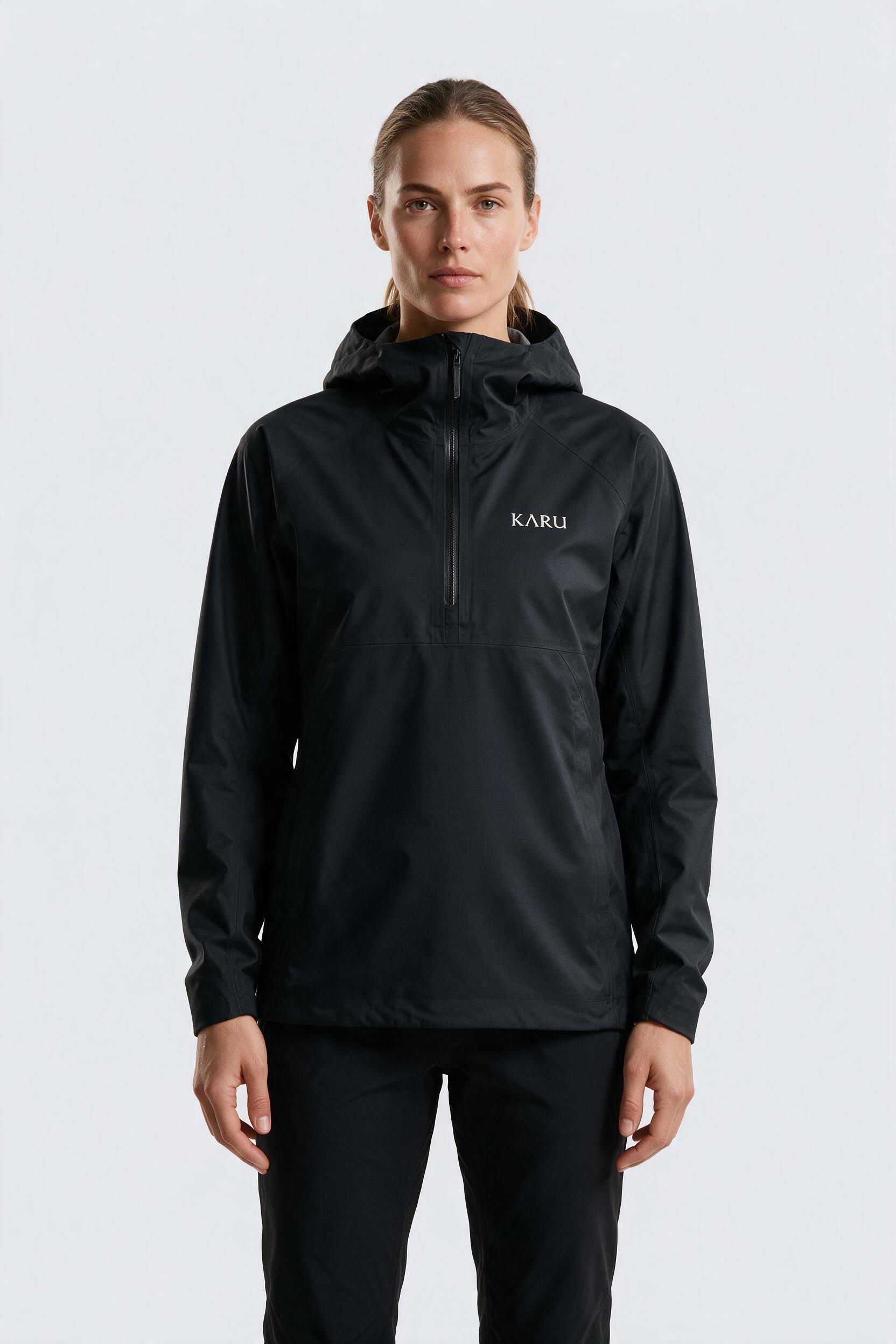 Kårsa Anorak in night black, worn by a model, studio product shot on a seamless neutral ground