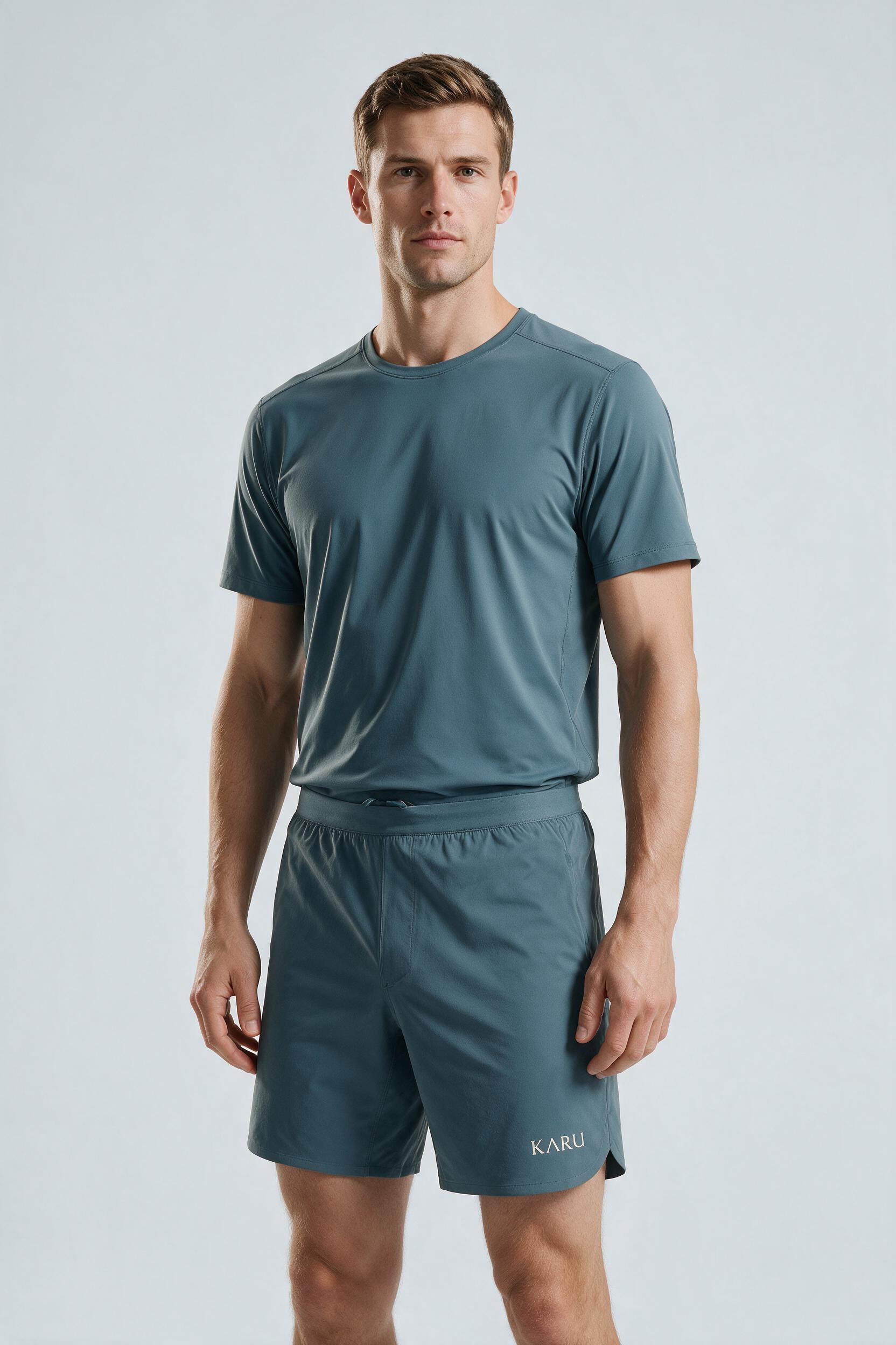 Kilpis Short in slate blue-grey, worn by a model, studio product shot on a seamless neutral ground