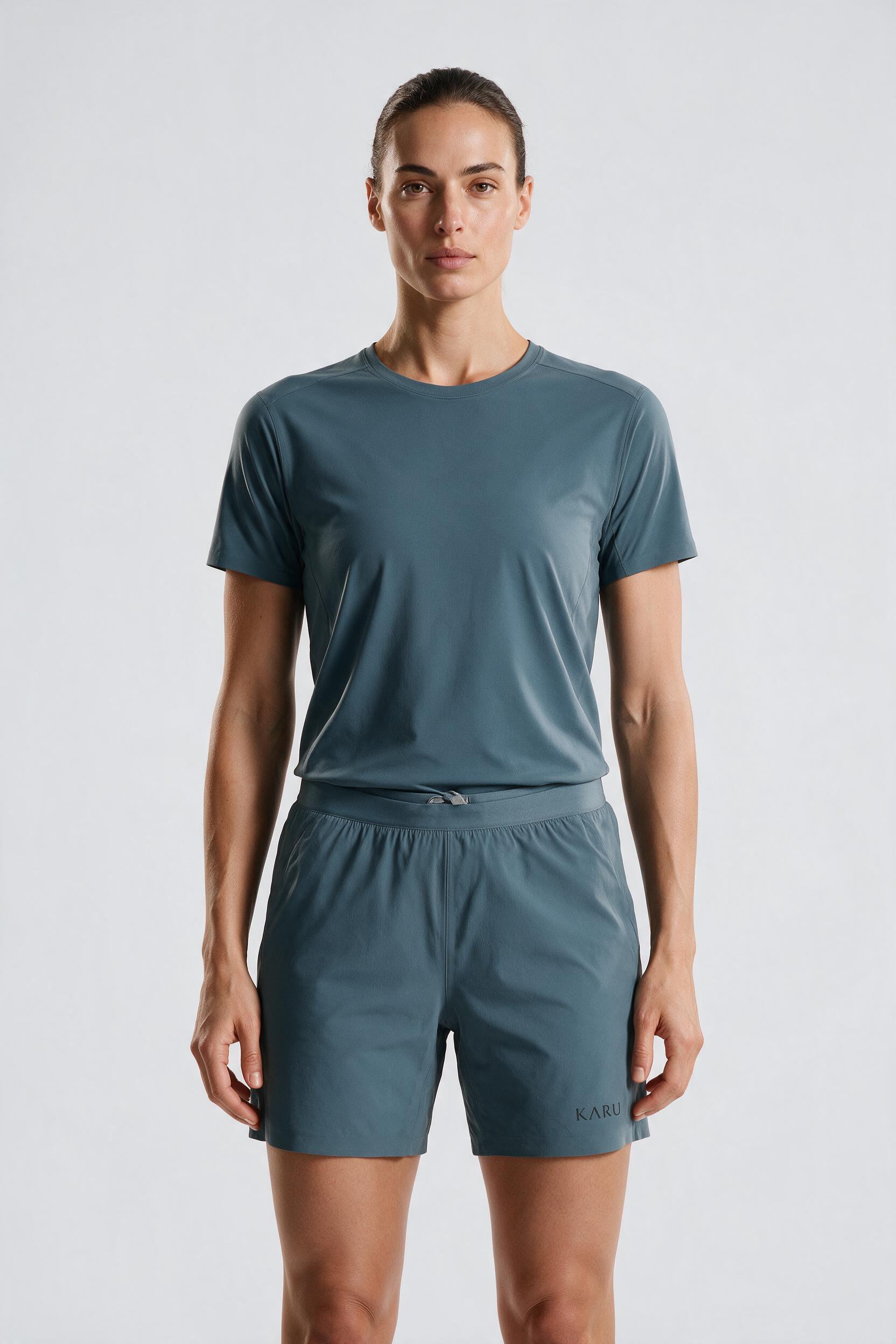 Kilpis Short in slate blue-grey, worn by a model, studio product shot on a seamless neutral ground