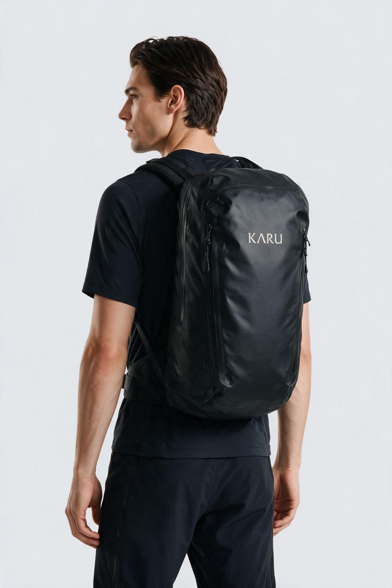 Kvikkjokk 65 pack in night black, worn on the back, studio product shot on a seamless neutral ground
