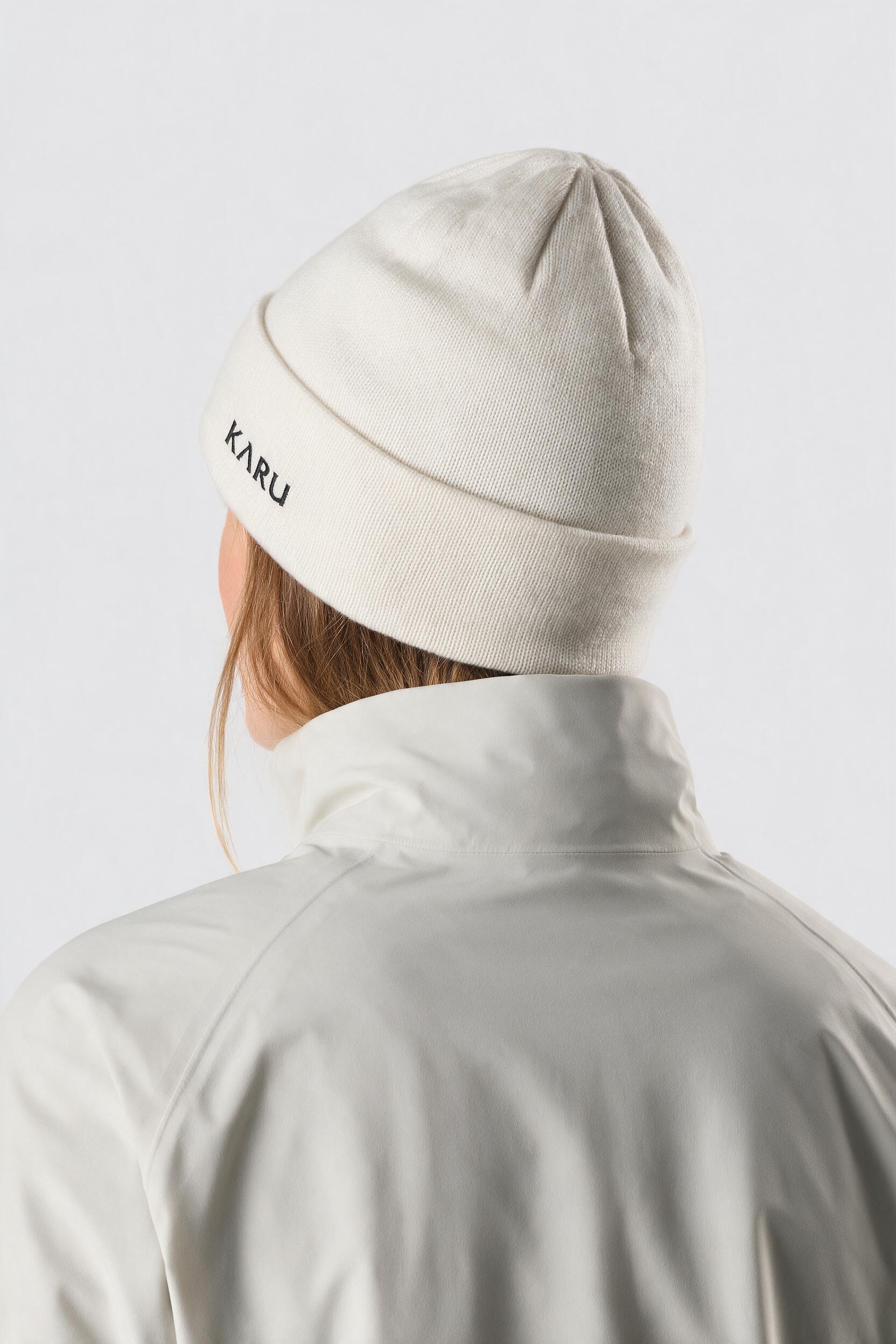 Låkta Beanie in bone, worn by a model, studio product shot on a seamless neutral ground
