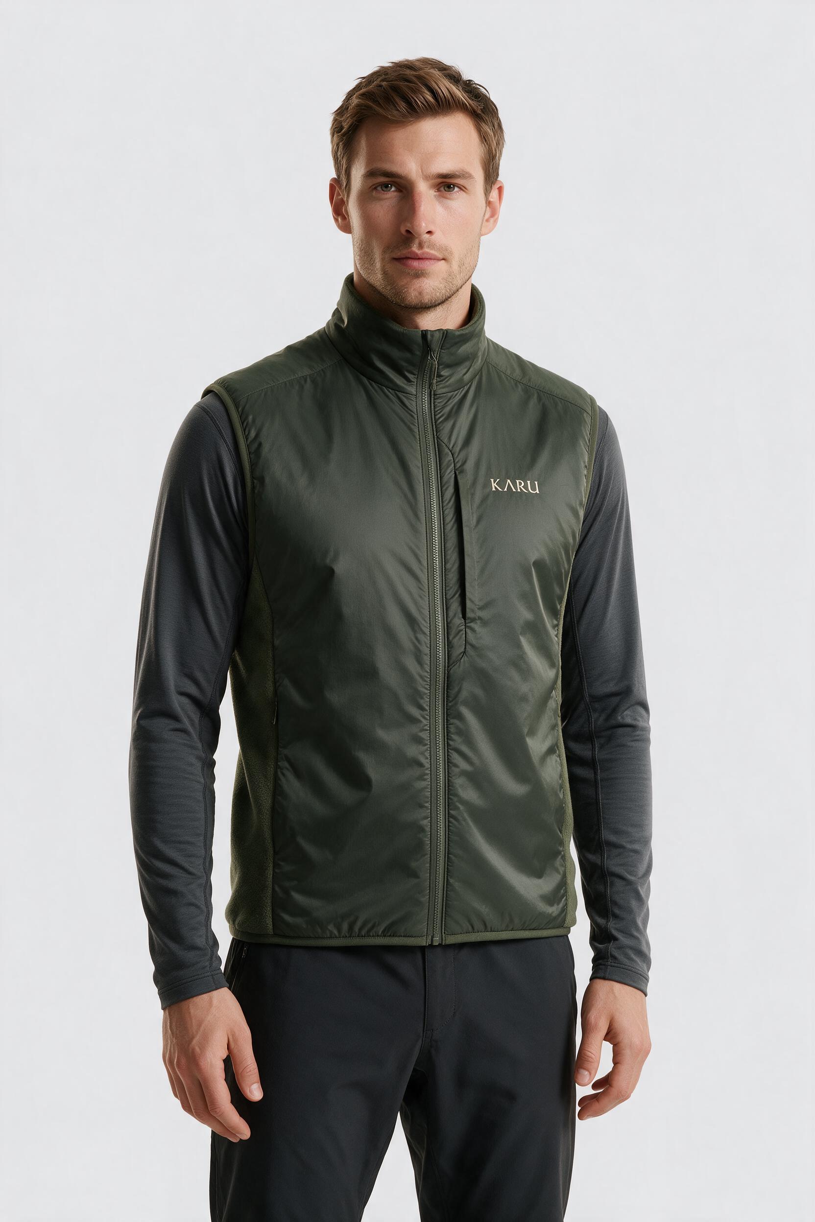 Muddus Vest in deep moss, worn by a model, studio product shot on a seamless neutral ground