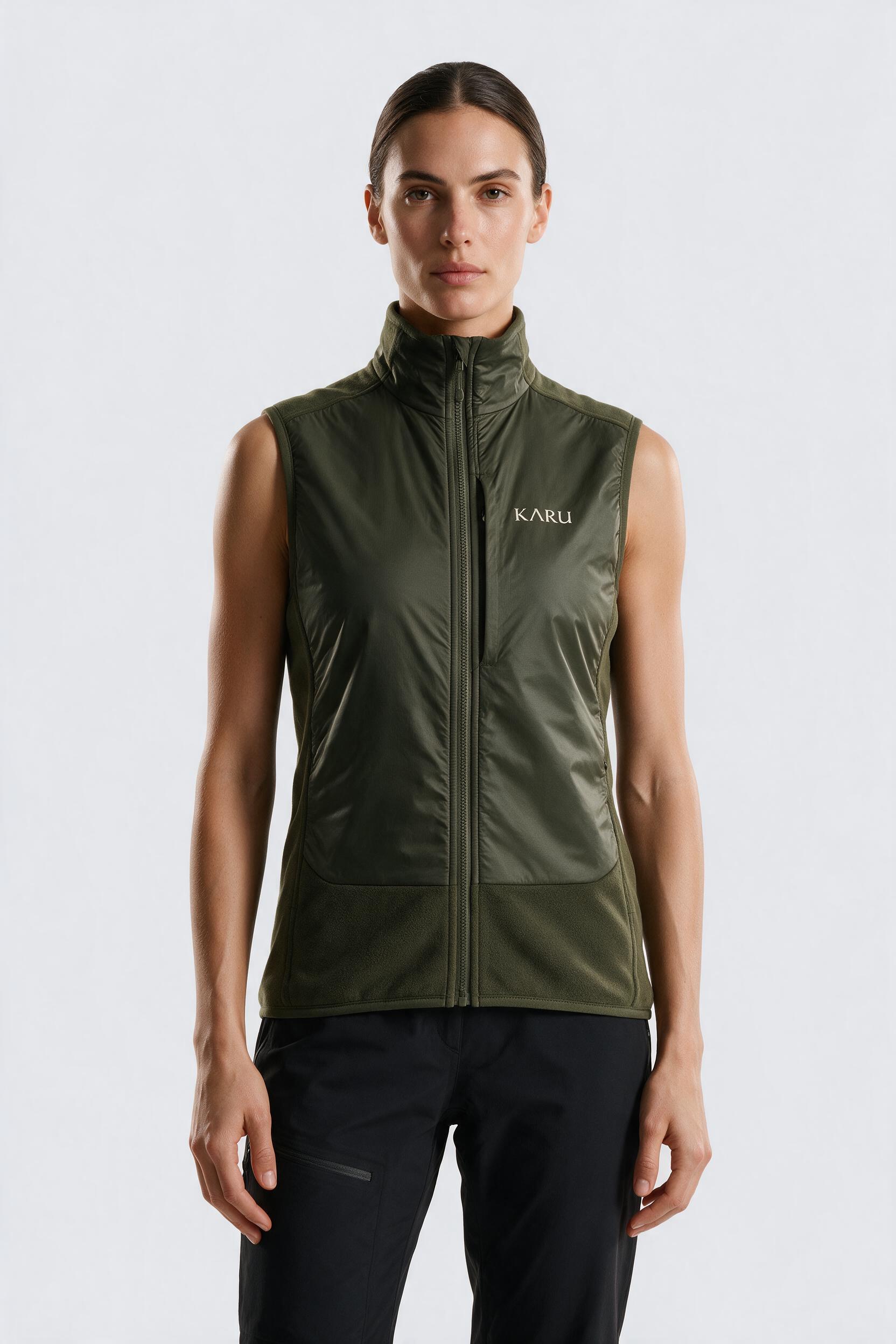 Muddus Vest in deep moss, worn by a model, studio product shot on a seamless neutral ground