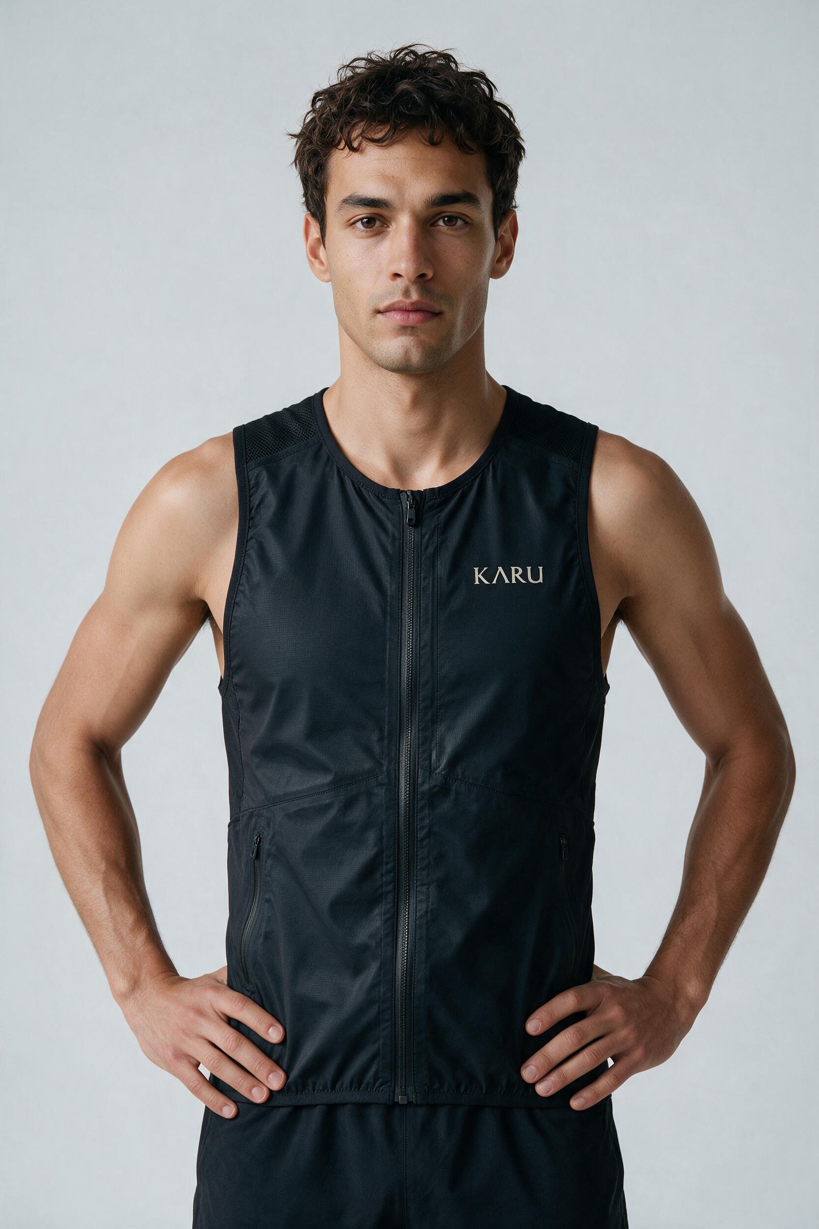 Njakka Vest 5 in night black, worn by a model, studio product shot on a seamless neutral ground