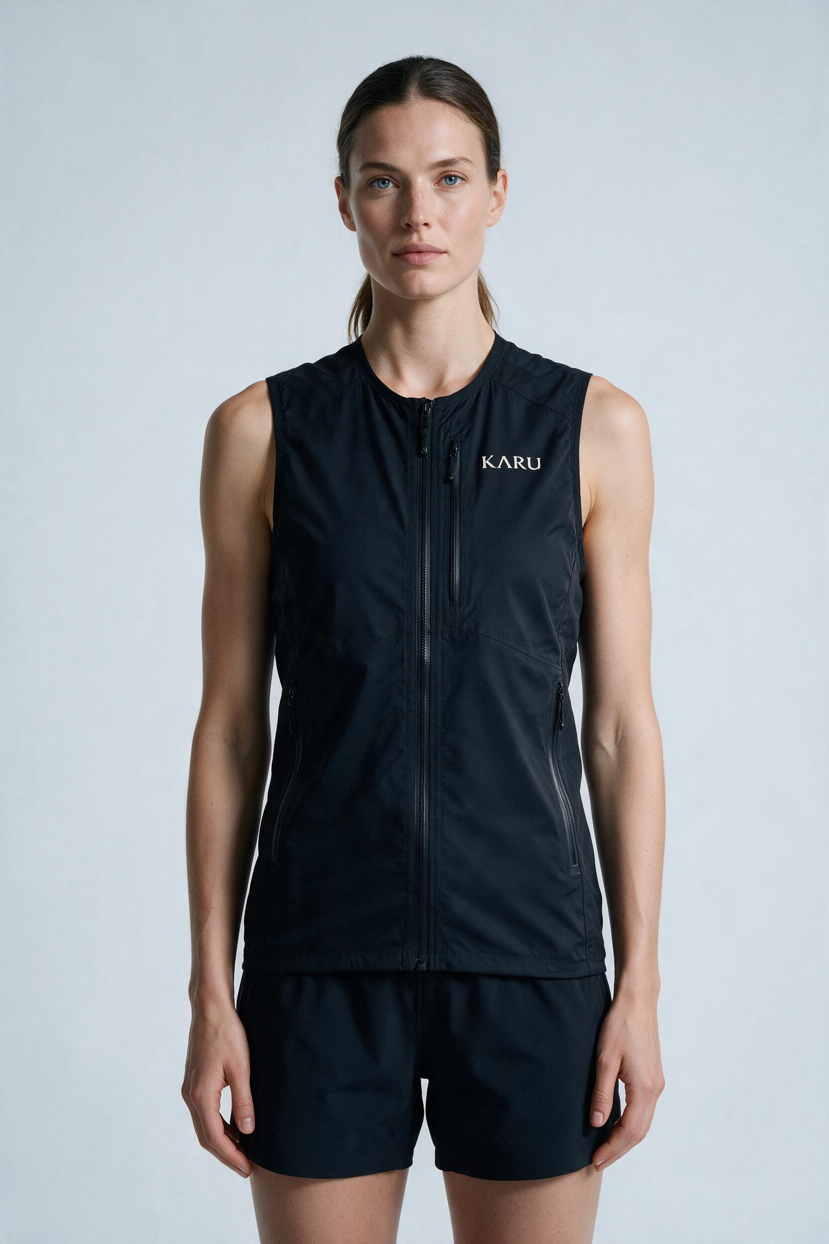 Njakka Vest 5 in night black, worn by a model, studio product shot on a seamless neutral ground