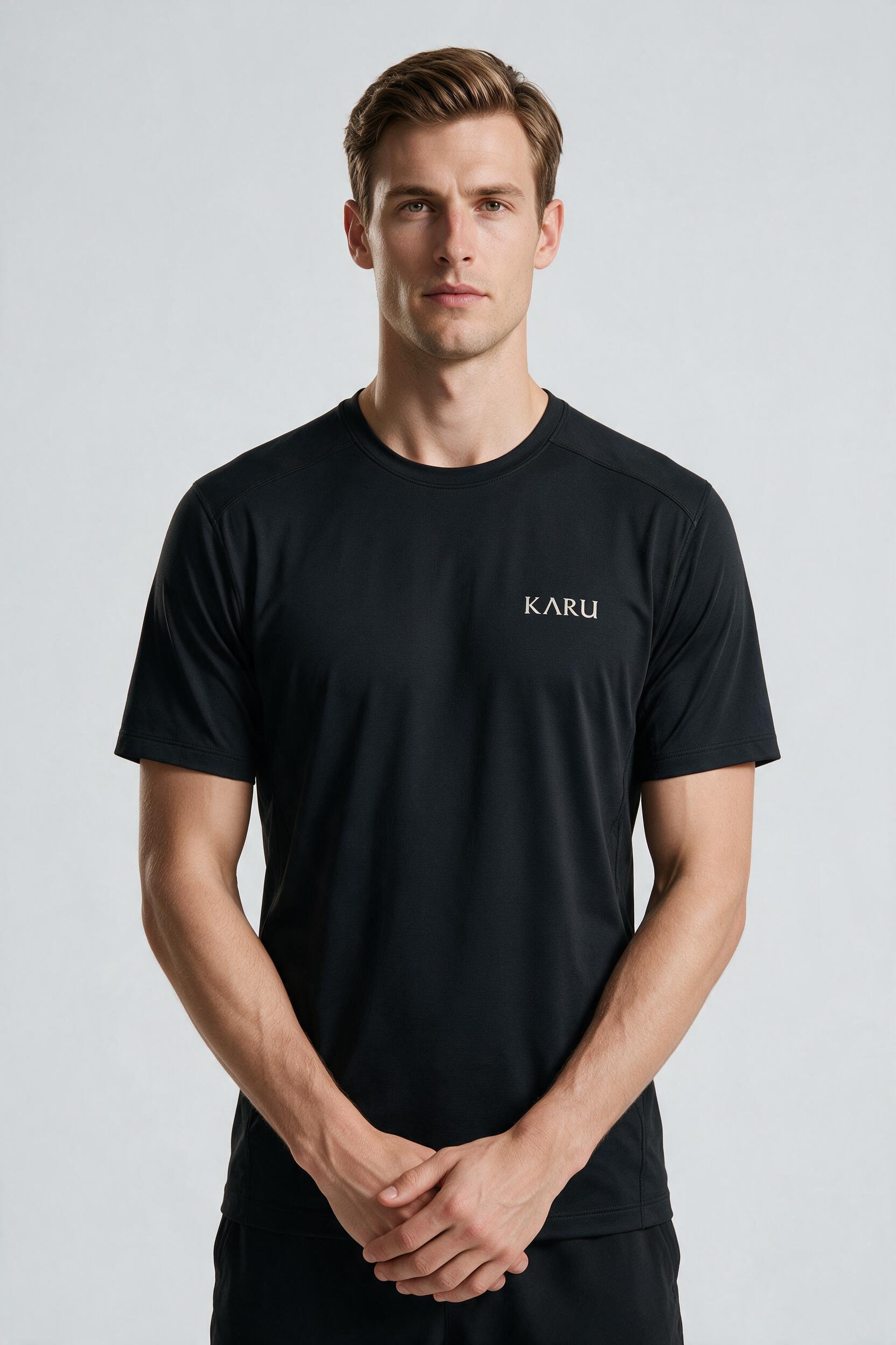 Pallas Tee in night black, worn by a model, studio product shot on a seamless neutral ground