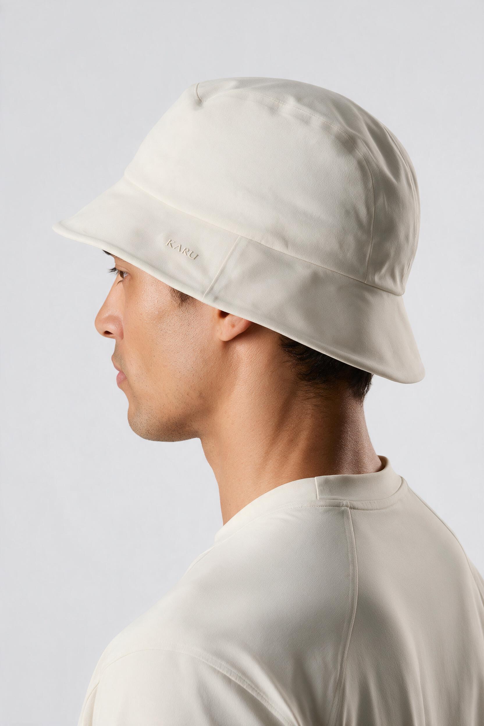 Saana Bucket Hat in bone, worn by a model, studio product shot on a seamless neutral ground