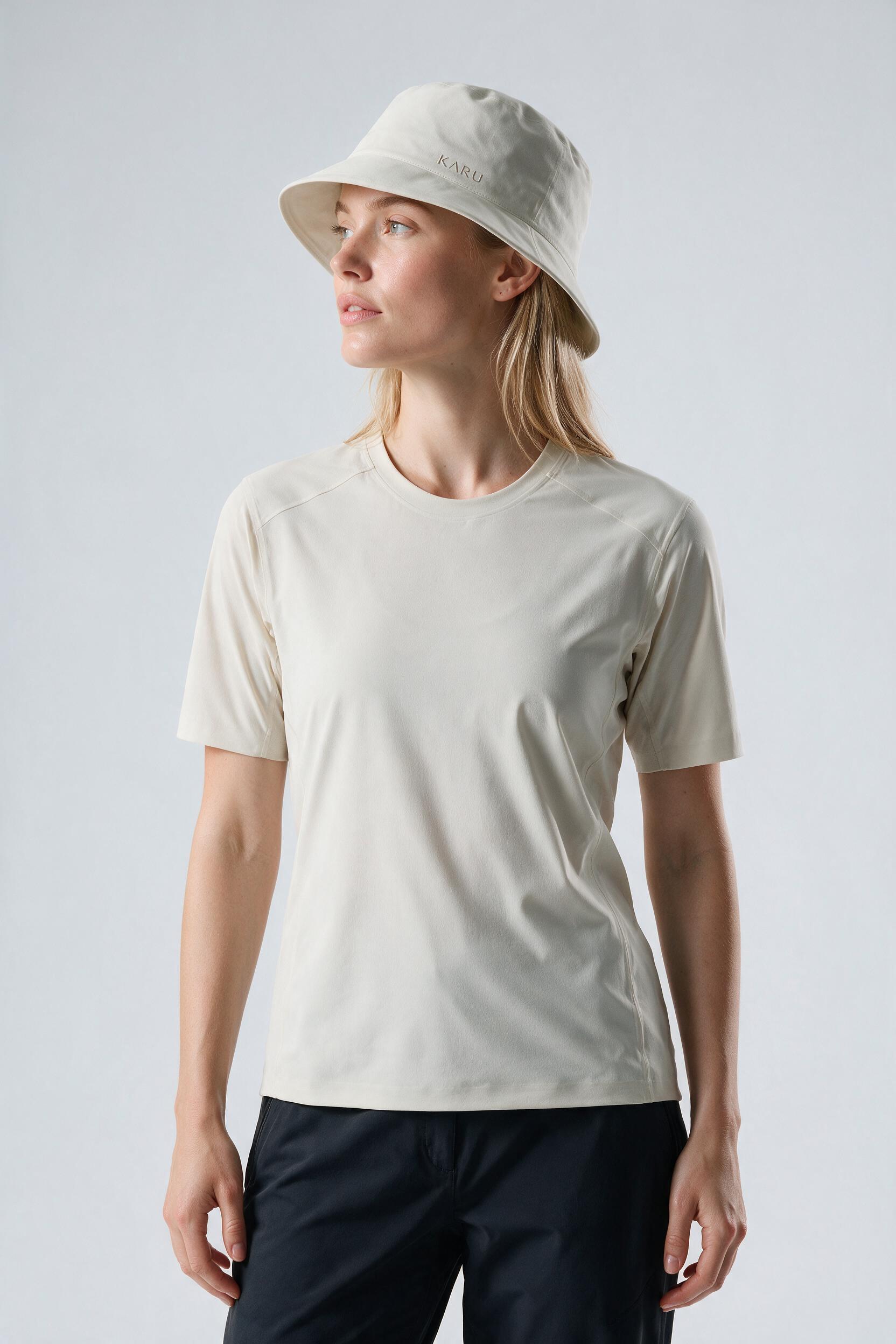 Saana Bucket Hat in bone, worn by a model, studio product shot on a seamless neutral ground