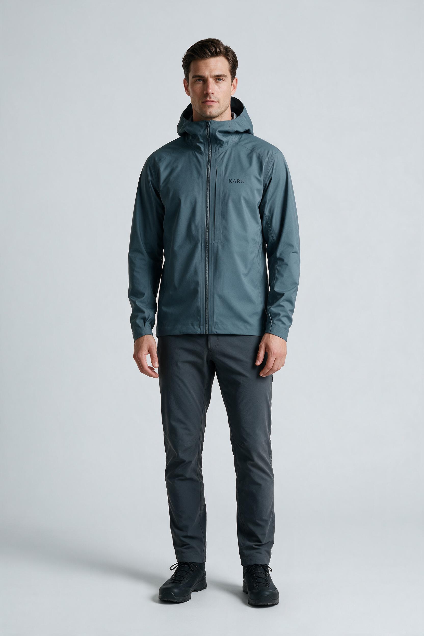 Singi Shell in slate blue-grey, worn by a model, studio product shot on a seamless neutral ground