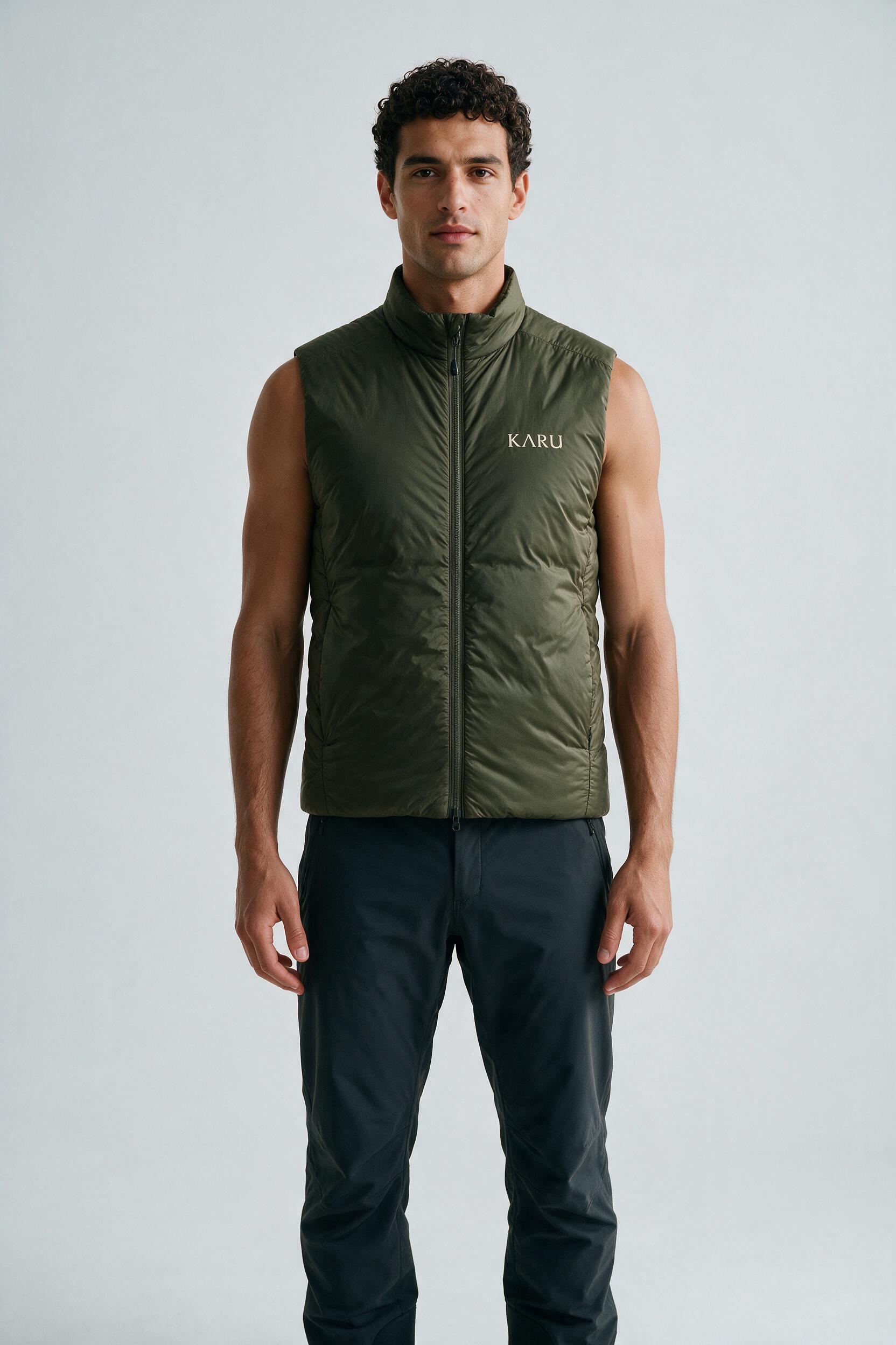 Sitas Vest Olive in dark olive, worn by a model, studio product shot on a seamless neutral ground