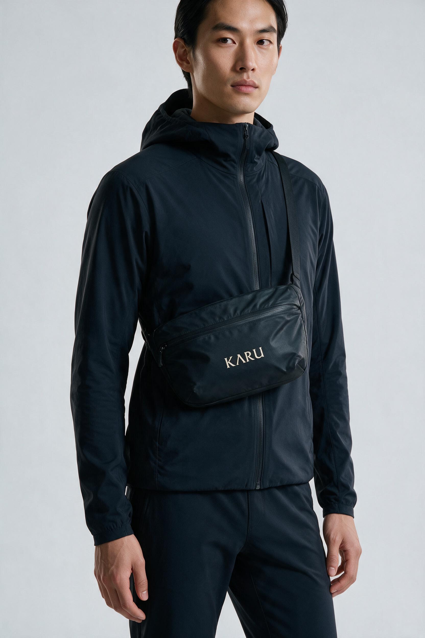 Vietas Crossbody pack in night black, worn on the back, studio product shot on a seamless neutral ground