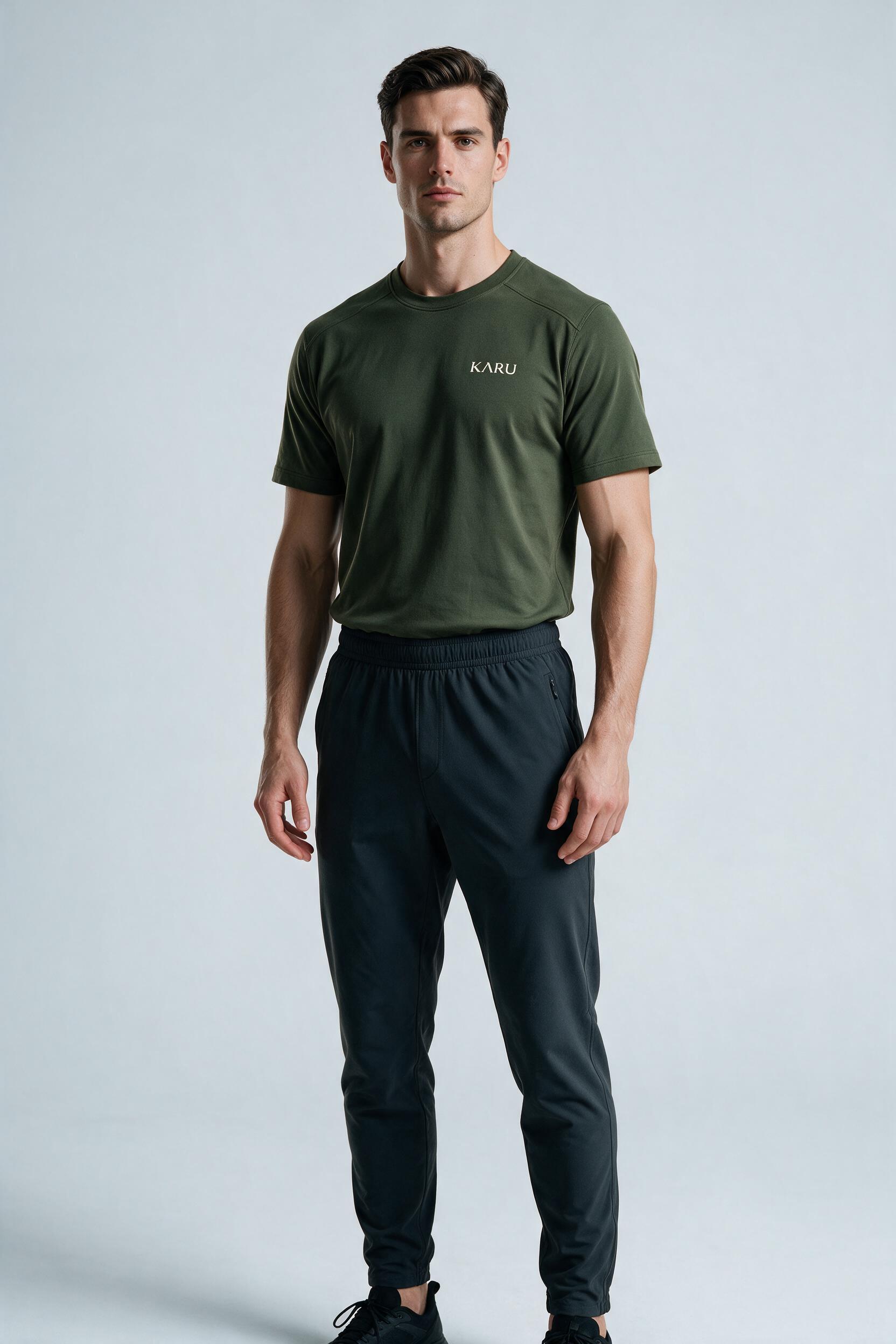 Ylläs Tee in deep moss, worn by a model, studio product shot on a seamless neutral ground