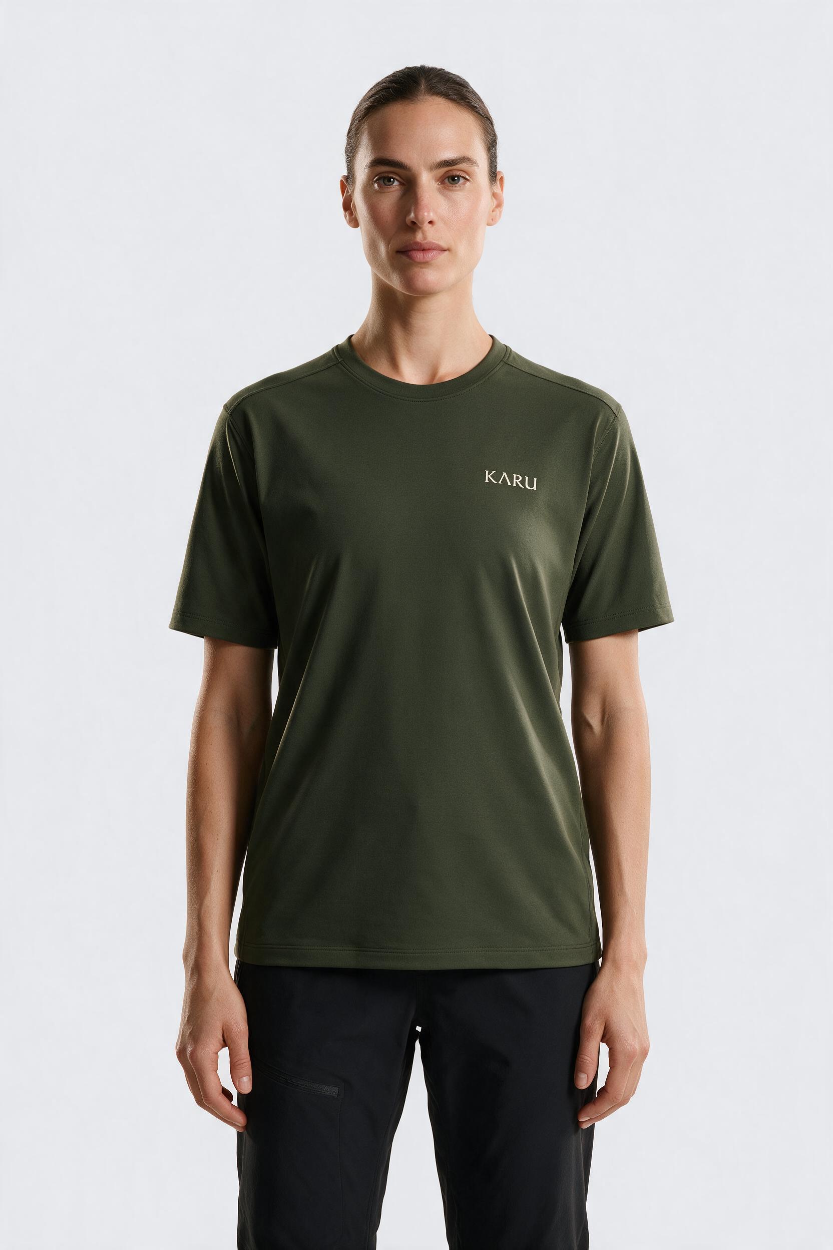 Ylläs Tee in deep moss, worn by a model, studio product shot on a seamless neutral ground